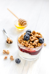 Healthy morning with granola breakfast on white kitchen table