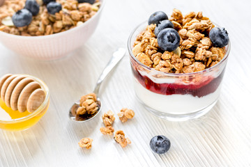 Healthy morning with granola breakfast on white kitchen table