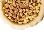 Raw homemade apple pie with cinnamon and walnuts, isolated on white background. With free space foe text.