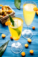 cocktail with physalis in glass on wooden background