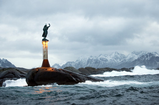 Light beacon with a sculpture on the top called Fiskerkona (fisherman's wife) Svolvaer, Lofoten, Norway, November 2008