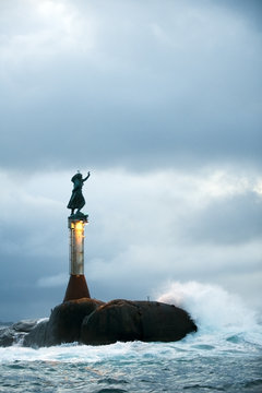 Light beacon with a sculpture on the top called Fiskerkona (fisherman's wife) Svolvaer, Lofoten, Norway, November 2008