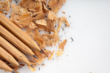 Pencil shavings on white background with copy space. selective focus.