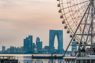 ferris wheel with cityscape in background in Suzhou,China.