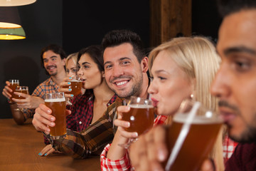 Young People Group In Bar, Friends Sitting At Wooden Counter Pub, Drink Beer Communication Party Celebration