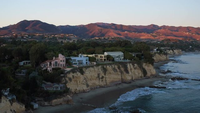 Malibu Aerial Point Dume Homes Sunset v22 Flying low over coastal homes panning at sunset.