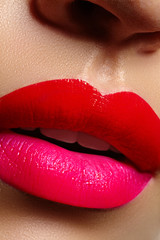 Cosmetics, makeup. Bright lipstick on lips. Closeup of beautiful female mouth with red and pink lip makeup. Part of face