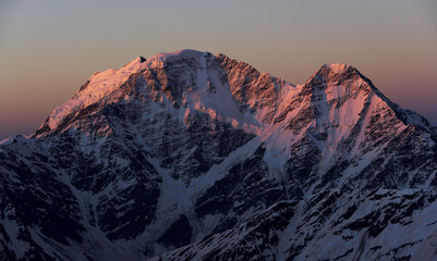 First red light on Nakratau (4,269m) (right) and Donguzorun (4,468m) seen from Elbrus, Caucasus, Russia, June 2008