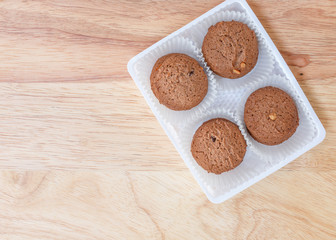 Cookies chocolate in plastic box on wood background