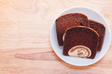 cake in dish and spoon fork on a wooden background