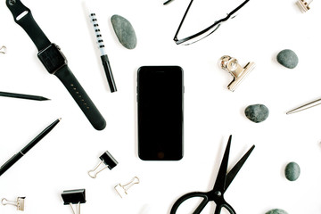 White office desk with supplies. mobile phone, glasses, scissors and office supplies on white background. Flat lay, top view office table desk.