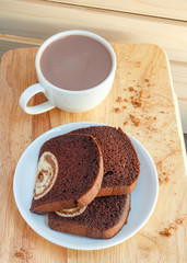 cake in dish and coffee on a wooden background