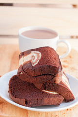 cake in dish and coffee on a wooden background