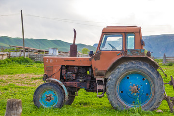 Very old rusted tractor parked in nature