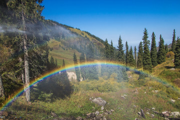 Rainbow at Tuyk su gorge near Shymbulak ski resort. Tien Shan mountains at summer time, Almaty, Kazakhstan
