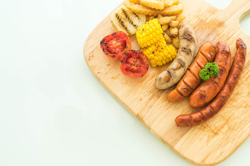 mix grilled sausage with vegetables and french fries