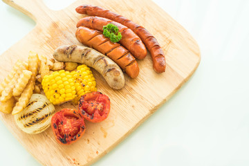 mix grilled sausage with vegetables and french fries