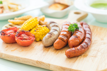 mix grilled sausage with vegetables and french fries