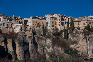 Fototapeta na wymiar View to hanging houses of Cuenca old town. Example of a medieval city, built on the steep sides of a mountain. Many houses are built right up to the cliff edge. Cuenca, Spain