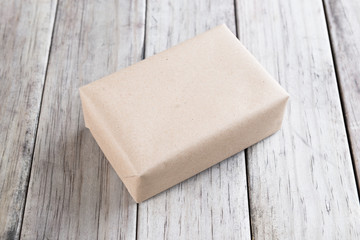 Cardboard box on a wooden background, Brown mail package parcel wrap delivery