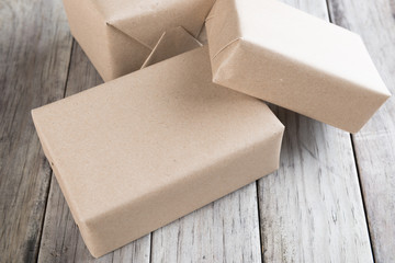 Cardboard box on a wooden background, Brown mail package parcel wrap delivery
