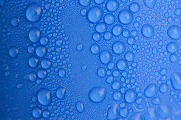 Water drops on blue curve paper cup