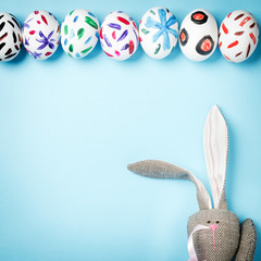 Easter bunny on a blue background. Rabbit. Easter ideas. Easter eggs. Space for text. Happy easter.