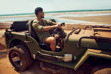 Man on jeep on the of road © ASjack