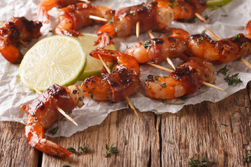 Grilled shrimp with bacon, thyme and lime close up. Horizontal