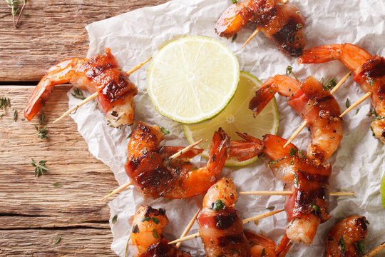 Grilled Shrimp With Bacon, Thyme And Lime Close Up On The Table. Horizontal Top View