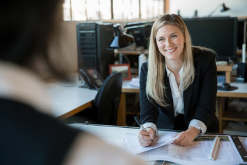 Cheerful happy corporate executive team member smiling at the office work place