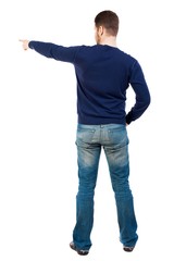 Back view of  pointing young men in jeans