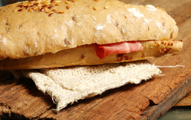 Rye bread put on brown color hard wood surface represent the food background and concept related idea.