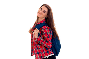 beautiful smiling girl in a Plaid Shirt with a backpack on your back is