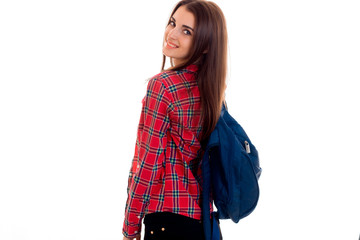 cute young girl with a backpack and a Plaid Shirt is worth turning back forward