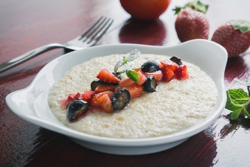 Oatmeal porridge with fruits and greens, hot and healthy food for Breakfast