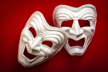 Comedy and Tragedy theatrical mask isolated on a red background