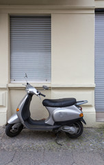 Old Fashioned Motor Scooter Parked at Sidewalk