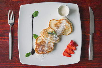 Hot Fritters with strawberry and sauce, breakfast