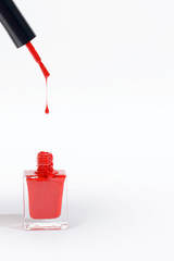 red nail polish bottle on white background 