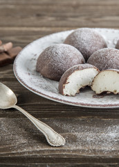Chocolate and curd cheese at wooden background