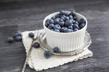 Cup with blueberry 
on a wooden background
