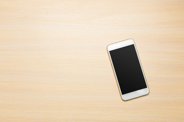 Smart phone on wooden background