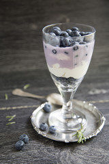 Cup with blueberry and smoothies 
on a wooden background
