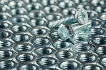 nuts, bolts, screws on a dark concrete background