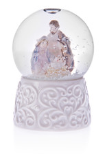 Snow globe with holy Mary, baby Jesus and Joseph on a ceramic base.