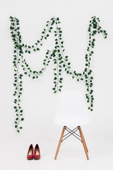 white chair with red shoes on a white background .