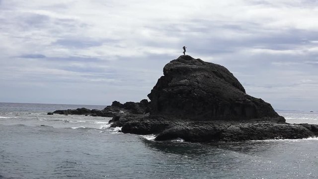 Indigenous Fijian man dance on a sea cliff in the Yasawa Islands of Fiji