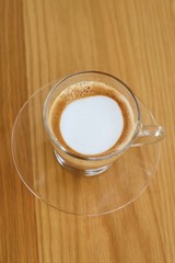 A glass of latte coffee.