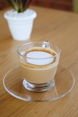 A glass of latte coffee.